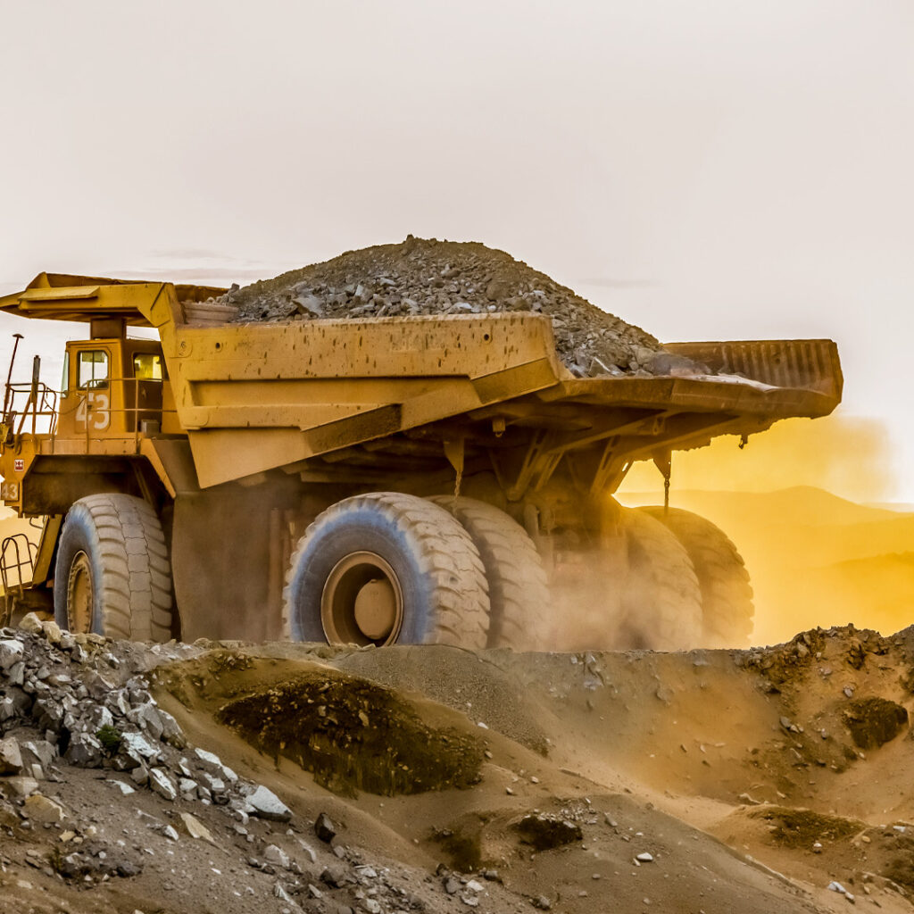 Heavy construction truck carrying rocks at an industrial worksite