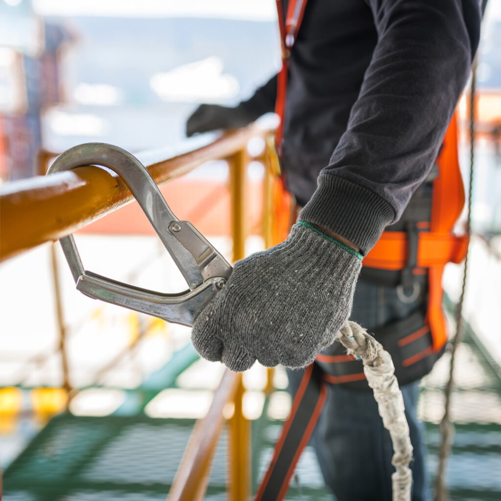 Worker wearing a safety harness while working at height